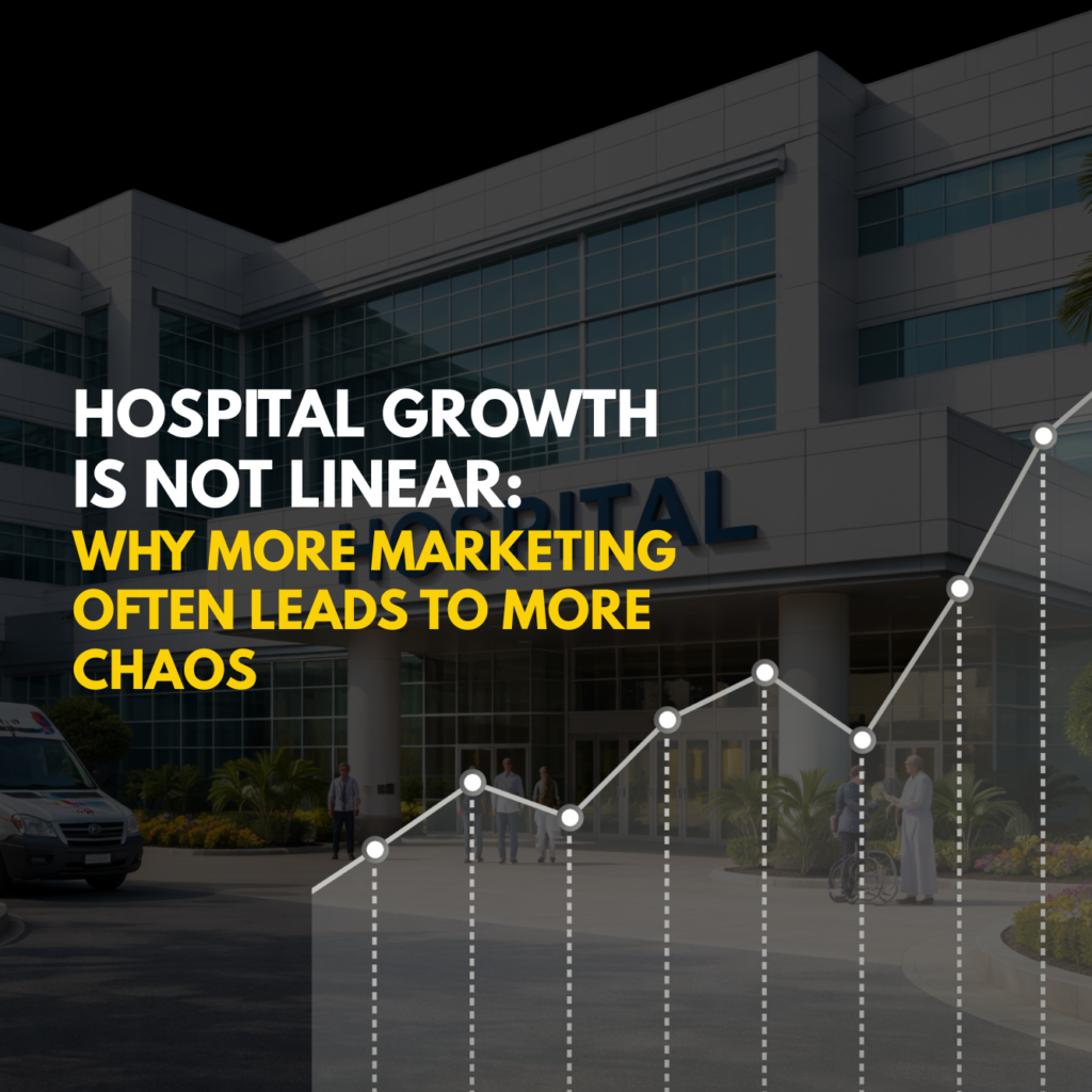 Modern Indian hospital building with patients, doctors, and ambulance at the entrance during daytime